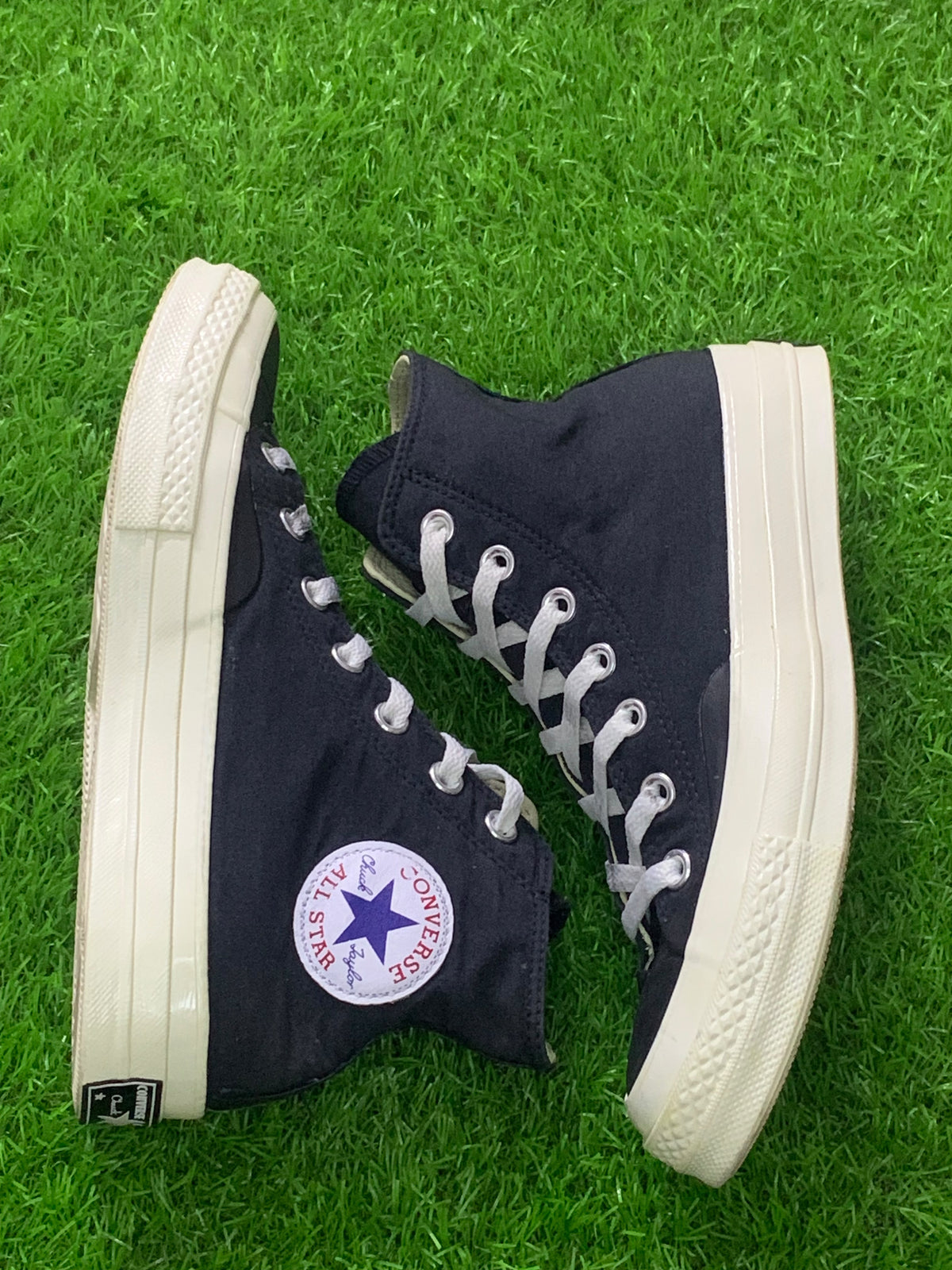 Converse black high-top sneakers side view with All Star patch