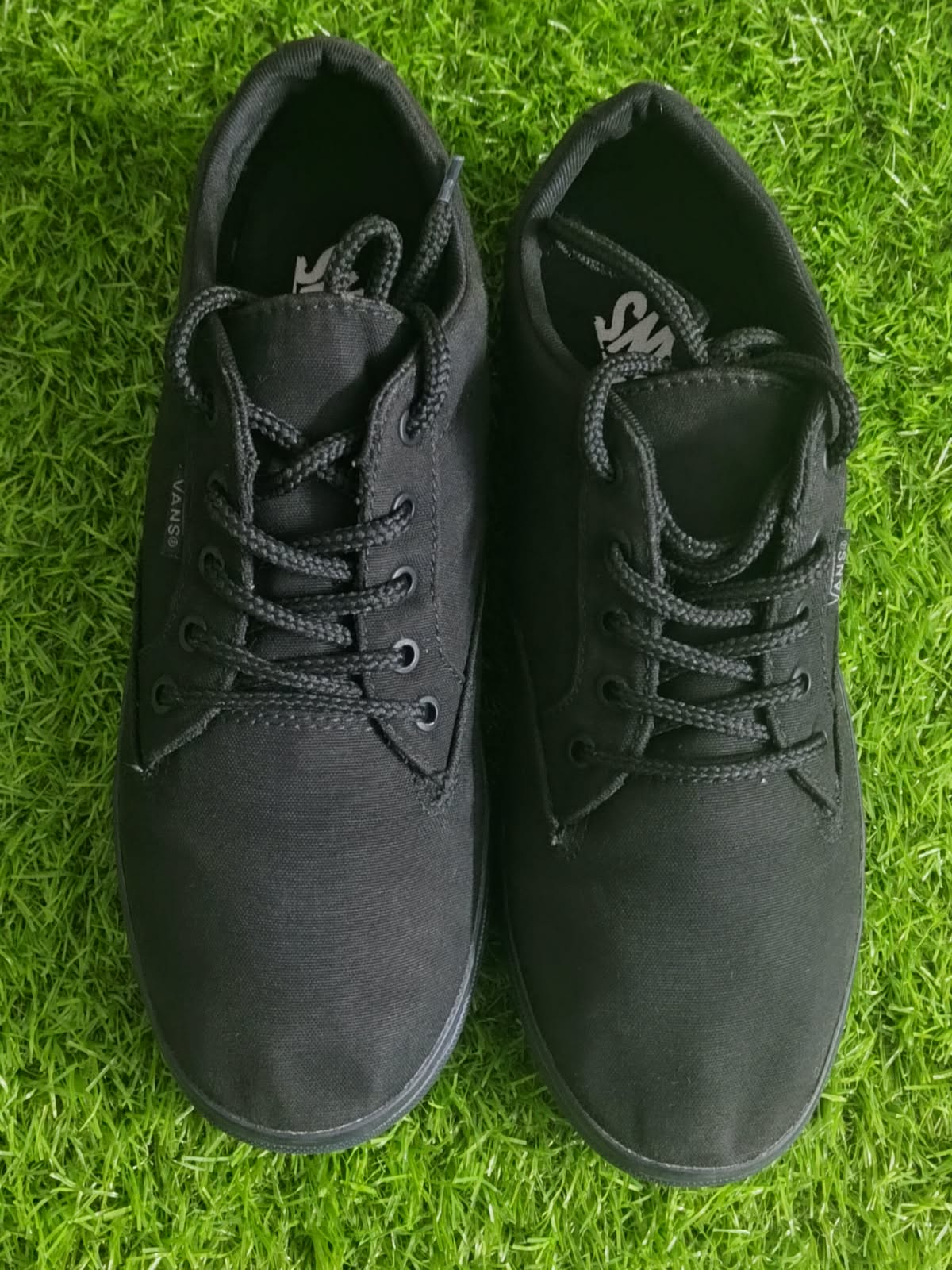 Vans all black low top sneakers front view