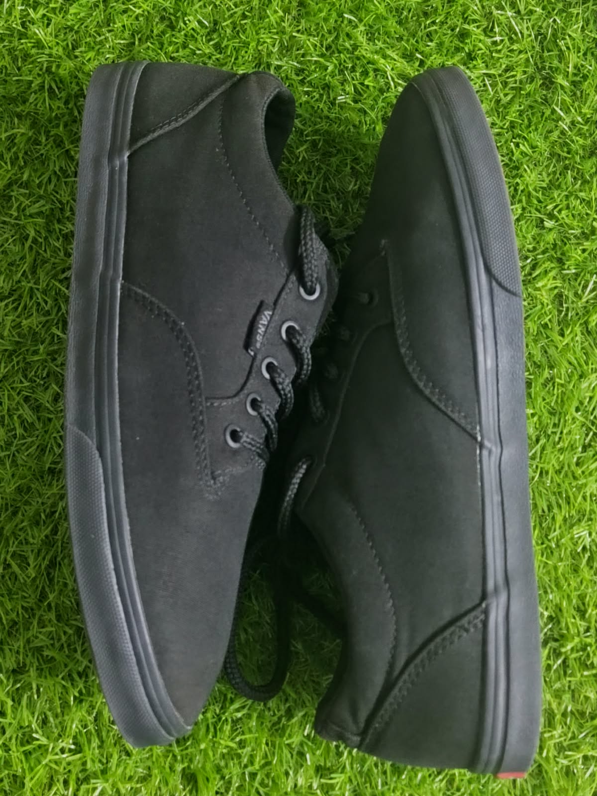 Vans all black sneakers side view